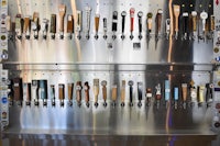 a bar with a lot of beer taps