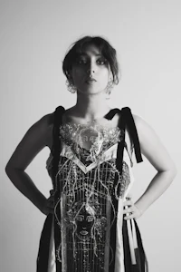 a black and white photo of a woman in a dress
