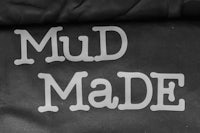 a black and white photo of the word mud made