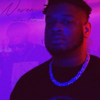 a man wearing a black shirt in front of a purple background