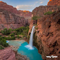 a waterfall in the middle of a canyon