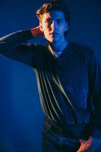 a young man is posing for a photo