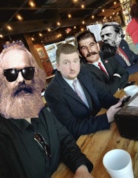 a group of people sitting at a table with beards and glasses