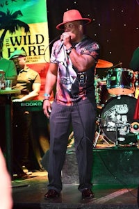 a man in a hat singing at a concert