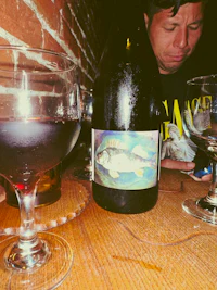 a bottle of wine and a glass of wine on a table