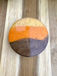 an orange and brown plate on a wooden table