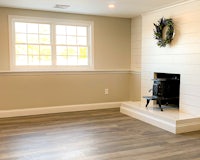 a room with hardwood floors and a fireplace