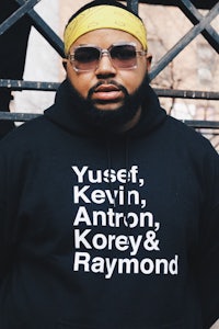a black hoodie with the words yussef kevin antonio korey ray