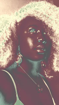 a woman with afro hair is posing for a photo
