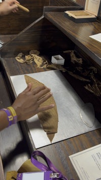 a woman is working with a piece of paper