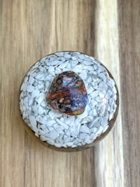a small glass bowl with a stone in it