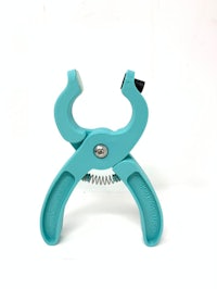 a blue plastic pliers on a white background
