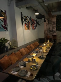 a dining room with a long table and chairs