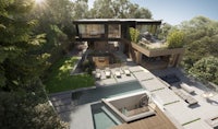 an aerial view of a modern home in the woods