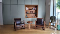 a living room with two chairs and a table