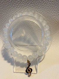 a clear bead bracelet hanging on a wall