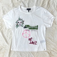 a white t - shirt with peace signs on it