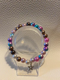 a bracelet with multi colored pearls and a star
