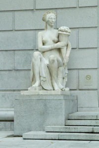 a statue of a woman holding a flower