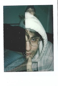 a photo of a man with glasses and a polaroid
