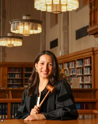 a woman holding a gavel in a library