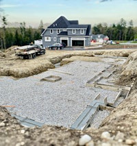 a house is being built with concrete foundations