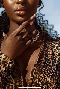 a woman in a leopard print dress posing for a magazine