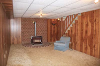 a room with a fireplace and wood paneled walls