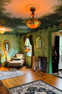 a living room with a mural painted on the wall