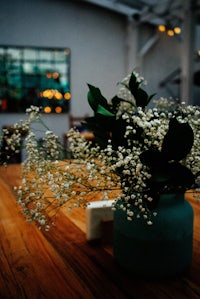 a blue vase filled with flowers on a table