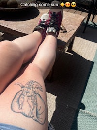 a woman's legs with a tattoo on them