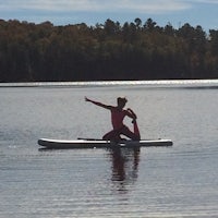 a person riding a surfboard on a body of water