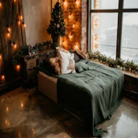 a bed with christmas lights in front of a window