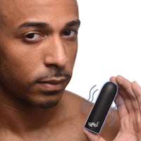 a man is holding an electronic device in his hand