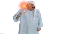 a man in a pajama costume holding a candle