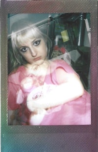a polaroid photo of a woman holding a baby