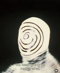 a black and white image of a man with a spiral on his face