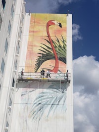 a painting of a flamingo on the side of a building