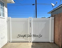 a white gate in front of a house