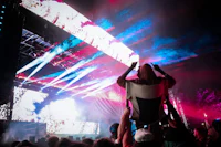 a group of people at a concert with bright lights in the background