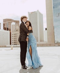 a man and woman hugging on the roof of a building