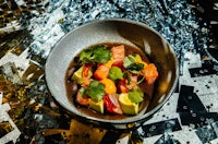 a bowl of food on top of a silver plate