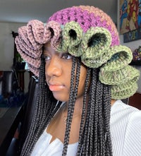 a woman wearing a crocheted ruffled hat