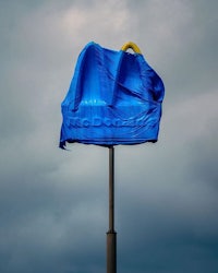 a blue mcdonald's sign is covered in a blue tarp