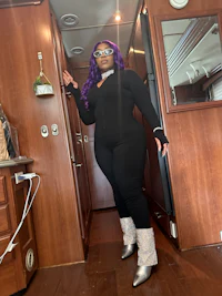a woman in a purple outfit standing in an rv