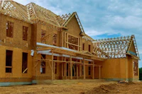 a house under construction with wooden framing