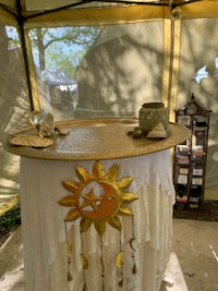 a table in a tent with a sun on it