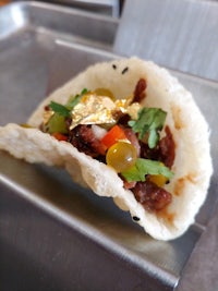 a taco is sitting on a tray