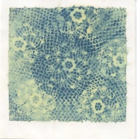 a piece of paper with blue and white lace on it