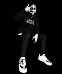 a black and white photo of a man sitting on a chair